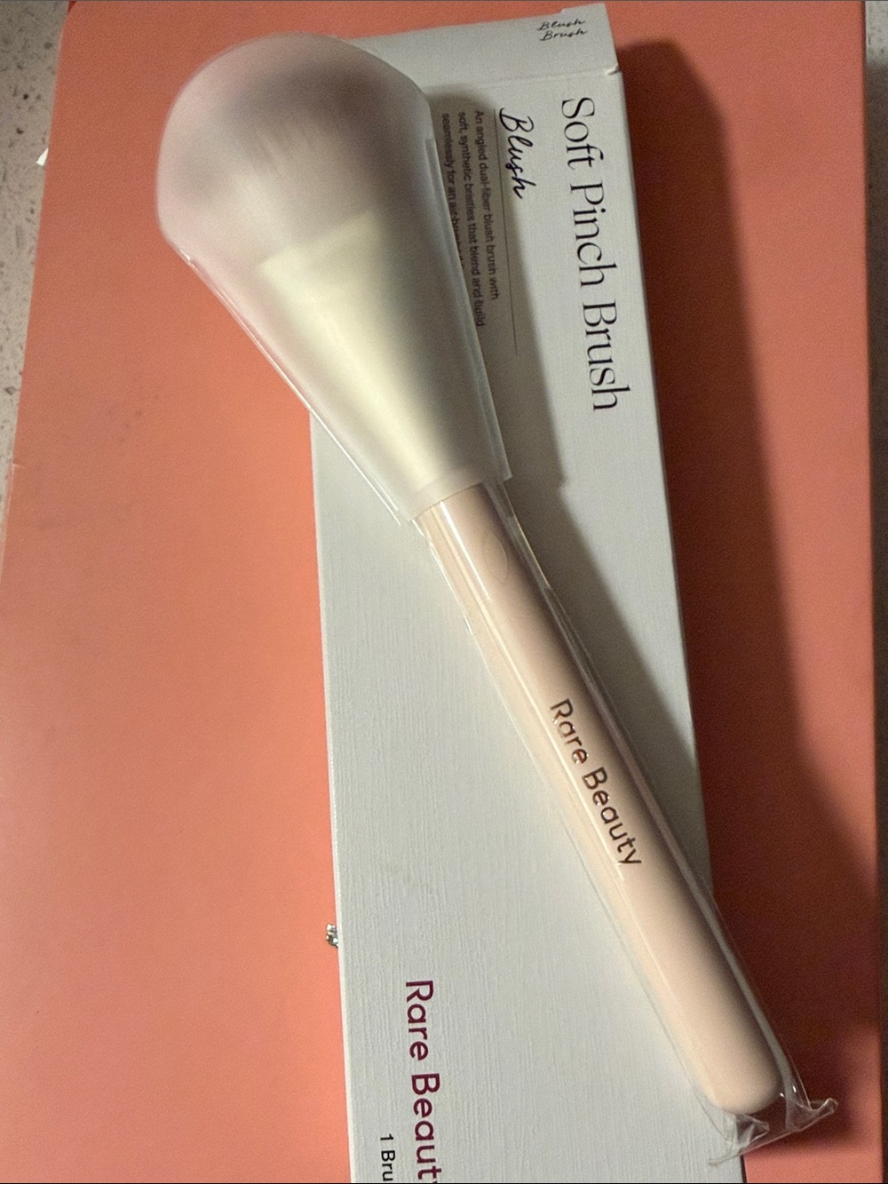 Rare Beauty blush brush in pale pink and white